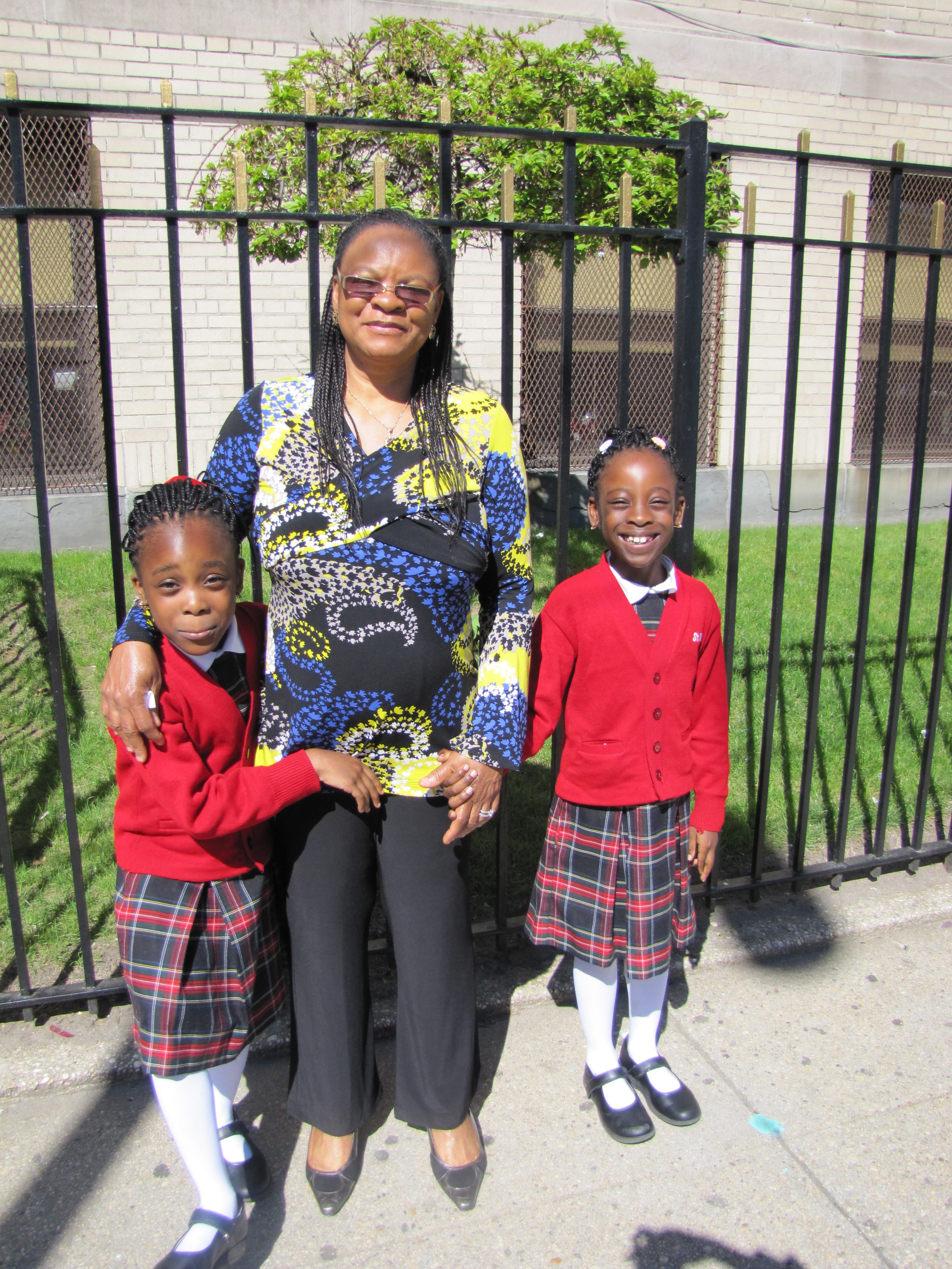 Mrs. Obazee and her twin daughters outside St. Mark School in Brooklyn.