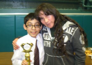 CSF Scholar Uziel Dominguez being congratulated by his mother, Isabel, after placing third in a speech contest in March, 2013. Uziel will begin his freshman year at Regis High School in a few weeks. 