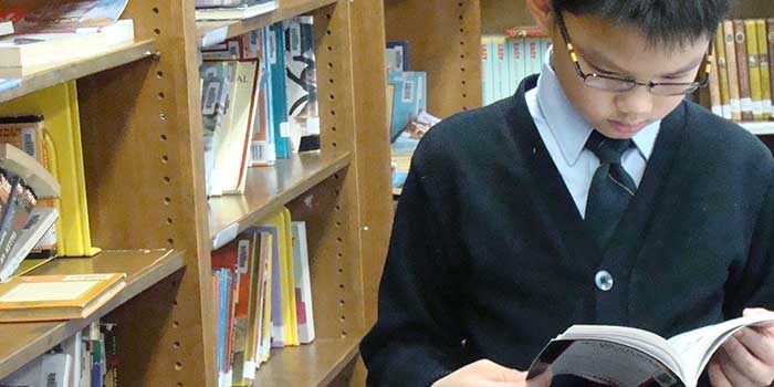 boy reading in library