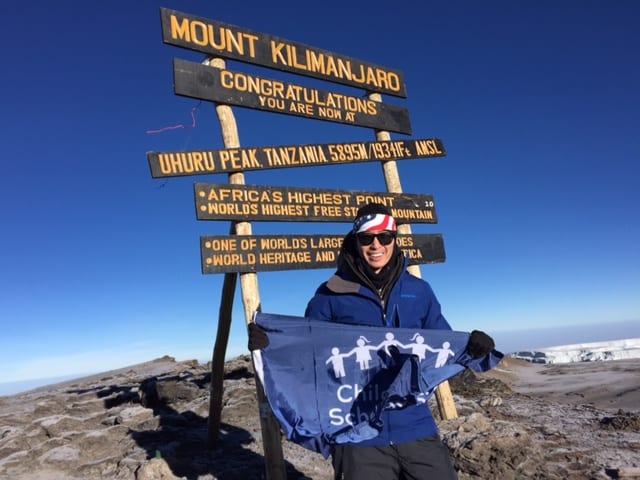 Kevin Song waves his CSF flag at Mt. Kilimanjaro's Uhuru Peak.